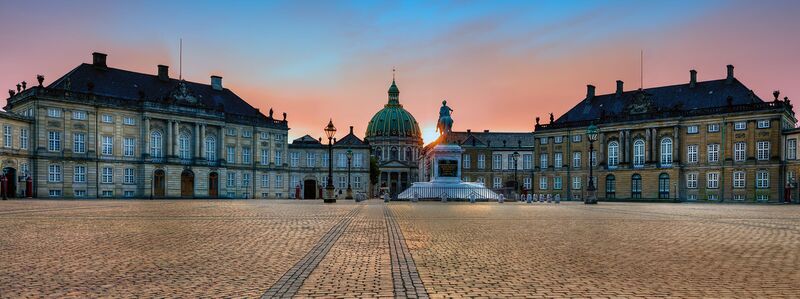 Exterior of the Royal Palace of Vittmark Hovet facing the Hovtorget square at dusk.